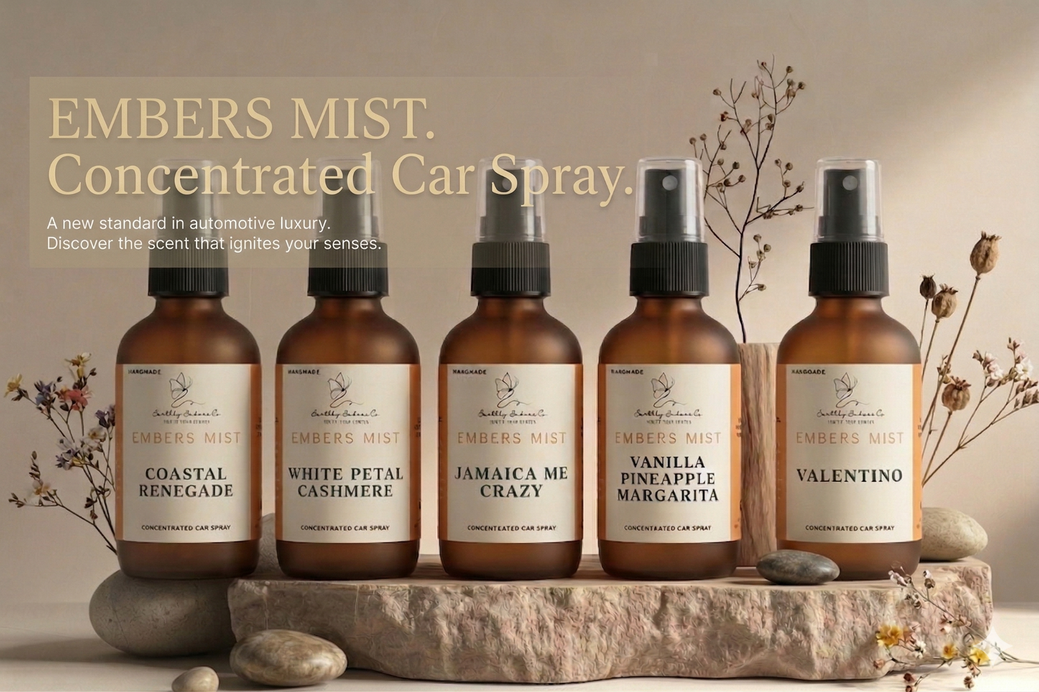Five Earthly Embers Co. Embers Mist luxury car sprays in amber bottles on a stone base. Scents: Coastal Renegade, White Petal Cashmere, Jamaica Me Crazy, Vanilla Pineapple Margarita, and Valentino. Professional automotive fragrance collection.